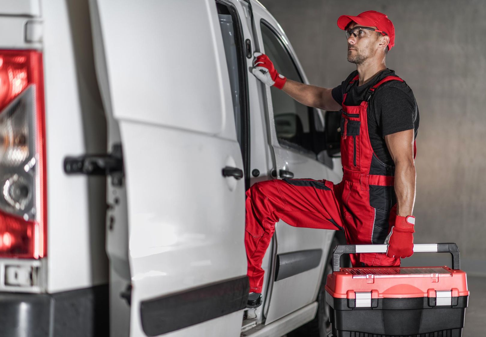 man carrying tools into a van